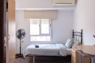 a bedroom with a bed and a window at Habitación Cardenal 4 in Valencia