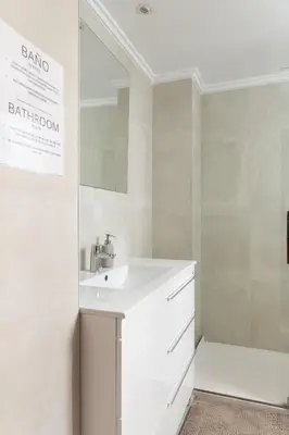 a white bathroom with a sink and a mirror at Habitación Cardenal 4 in Valencia