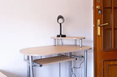 a table with a lamp on it next to a door at Habitación Cardenal 4 in Valencia