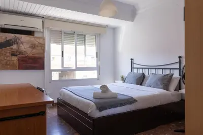 a bedroom with a large bed and a window at Habitación Cardenal 5 in Valencia