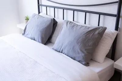 a white bed with two pillows on it at Habitación Cardenal 5 in Valencia