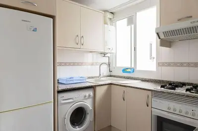 a kitchen with a washing machine and a sink at Habitación Cardenal 5 in Valencia