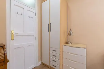 a white closet with a door and a dresser in a room at Central Apartment Sleeps 6 Fast Wi-Fi 2 Bathrooms in Valencia