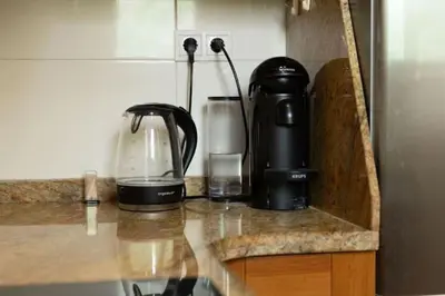 a counter with affeepot and a coffee maker on it at Central Apartment Sleeps 6 Fast Wi-Fi 2 Bathrooms in Valencia
