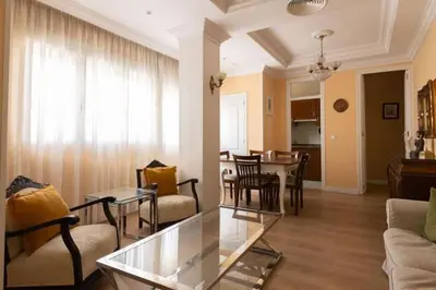 a living room with a glass table and a dining room at Central Apartment Sleeps 6 Fast Wi-Fi 2 Bathrooms in Valencia
