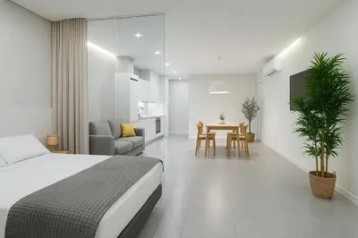 a bedroom with a bed and a table and chairs at Formidable Apartments in Valencia