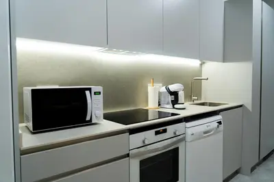 a kitchen with a microwave and a sink at Formidable Apartments in Valencia