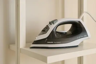 a black and white iron sitting on a shelf at Formidable Apartments in Valencia