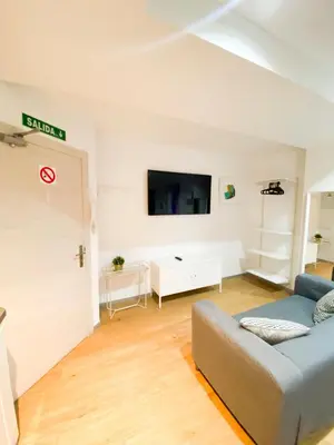 a living room with a couch and a flat screen tv at Marques de Caro Rooms Luxury in Valencia
