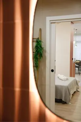 a mirror reflection of a bed in a room at SANCHEZ Y LASERNA STAYS Moderno Apartamento en Valencia in Valencia