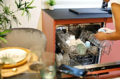 a dishwasher with dishes in it next to a table at SANCHEZ Y LASERNA STAYS Moderno Apartamento en Valencia in Valencia