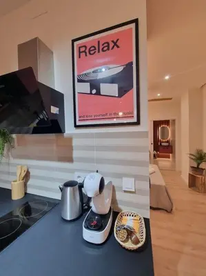 a kitchen with a counter top with a tea maker on it at SANCHEZ Y LASERNA STAYS Moderno Apartamento en Valencia in Valencia