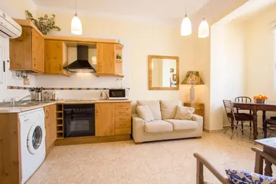 a kitchen and living room with a couch and a table at Valencia central apartment in Valencia