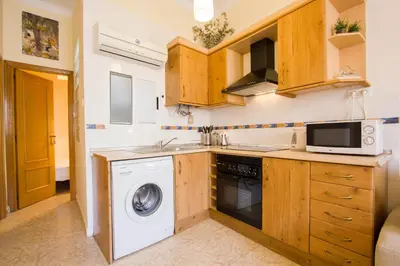 a kitchen with a washing machine and a microwave at Valencia central apartment in Valencia