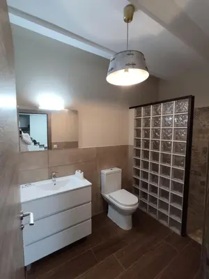 a bathroom with a toilet and a sink and a mirror at Casa Bonaire in Chella