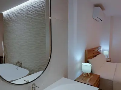 a bathroom with a sink and a mirror at Bellver Home Apartamentos in Chella