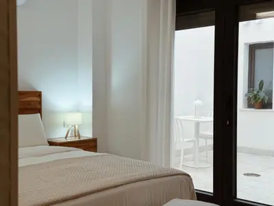a bedroom with a bed and a view of a table at Bellver Home Apartamentos in Chella