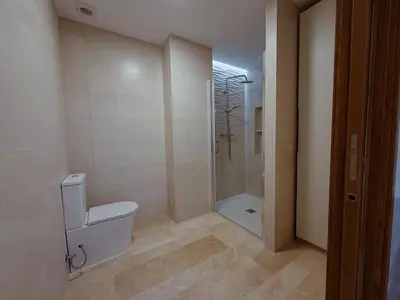 a bathroom with a toilet and a shower in it at Bellver Home Apartamentos in Chella