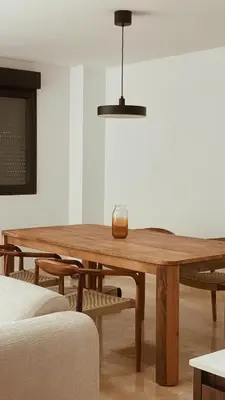 a dining room with a wooden table and chairs at Bellver Home Apartamentos in Chella