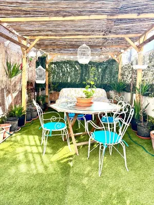 a patio with a table and chairs on grass at Casa típica Valenciana in Valencia