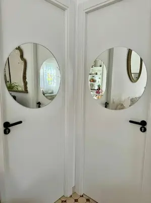 two mirrors on the door of a room at Casa típica Valenciana in Valencia