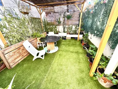 a patio with a table and chairs and grass at Casa típica Valenciana in Valencia