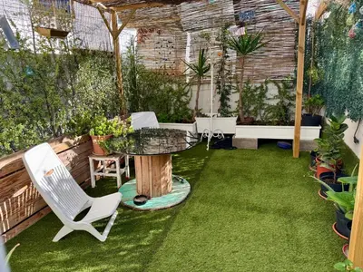 a patio with a table and chairs in a garden at Casa típica Valenciana in Valencia