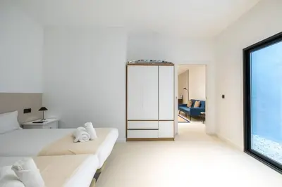 a white room with a bed and a large window at Flats nou Mestalla in Valencia
