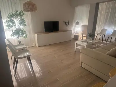 a living room with a couch and a tv at Ca Maruja in Cullera