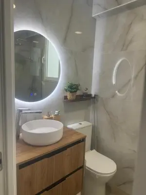 a bathroom with a sink and a toilet and a mirror at Ca Maruja in Cullera