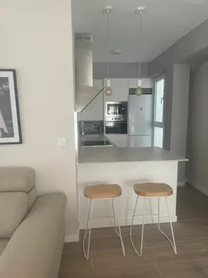 a kitchen with two stools and a counter in a room at Ca Maruja in Cullera