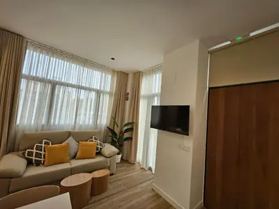a living room with a couch and a flat screen tv at HOB Miracle in Valencia