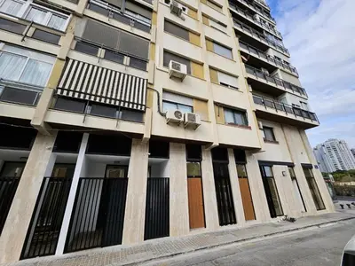 a tall building with windows and doors on a street at HOB Miracle in Valencia
