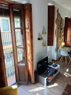 a room with a door and a table and a desk at Cozy flat in old town in Valencia