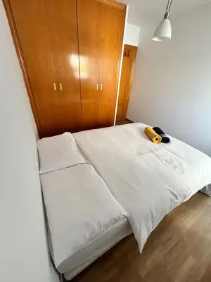 a small bedroom with a bed with a wooden cabinet at Cute and Cosy Room in Valencia