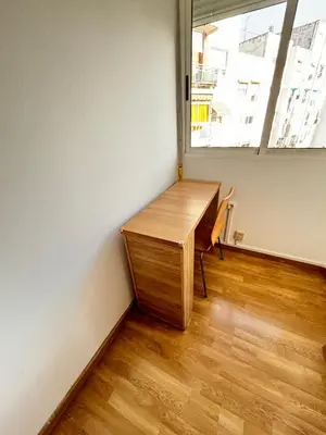 a wooden desk in a room with a window at Cute and Cosy Room in Valencia