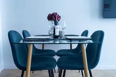 a dining room table with green chairs and a glass table at Luxe Appartement in Valencia - Dichtbij strand in Valencia