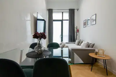 a living room with a couch and a table with chairs at Luxe Appartement in Valencia - Dichtbij strand in Valencia