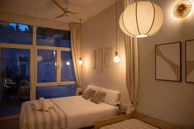 a bedroom with a bed and a large window at Apartamento con terraza Junto a Ruzafa in Valencia