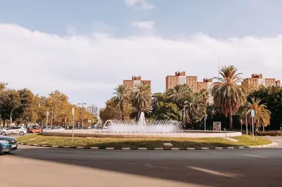 a fountain in the middle of a city with buildings at Apartamento con terraza Junto a Ruzafa in Valencia