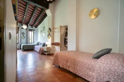 a bedroom with a bed and a clock on the wall at Apartamentos Mercado Central in Valencia