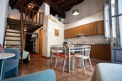 a kitchen and dining room with a table and chairs at Apartamentos Mercado Central in Valencia