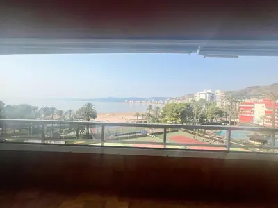 a view of a beach from a window of a building at Florazar 2 Apartamento frente al mar en Cullera in Cullera