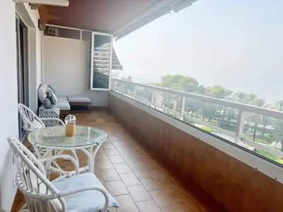 a balcony with a table and chairs and a view of the ocean at Florazar 2 Apartamento frente al mar en Cullera in Cullera