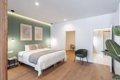a bedroom with a large bed and a green wall at SariStays Valencia Urban Chic Loft in Valencia