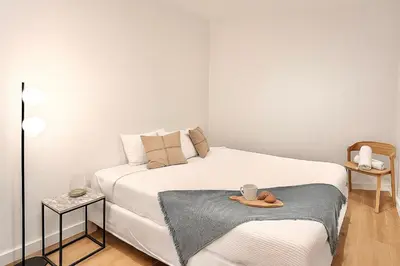 a small bedroom with a white bed with a tray on it at SariStays Valencia Urban Chic Loft in Valencia