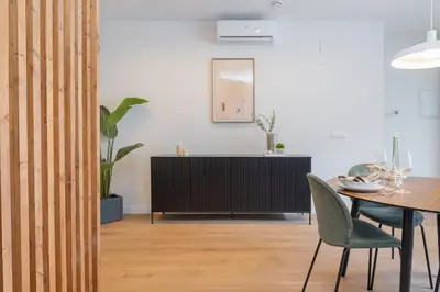 a dining room with a table and a cabinet at SariStays Valencia Urban Chic Loft in Valencia