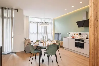 a kitchen and dining room with a table and chairs at SariStays Valencia Urban Chic Loft in Valencia