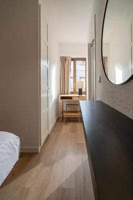 a bedroom with a large mirror and a desk at VLC HOST - Don Juan de Austria in Valencia