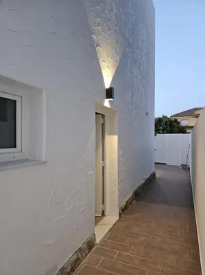 a hallway of a white building with a light on it at Chalet frente al Mar in Cullera